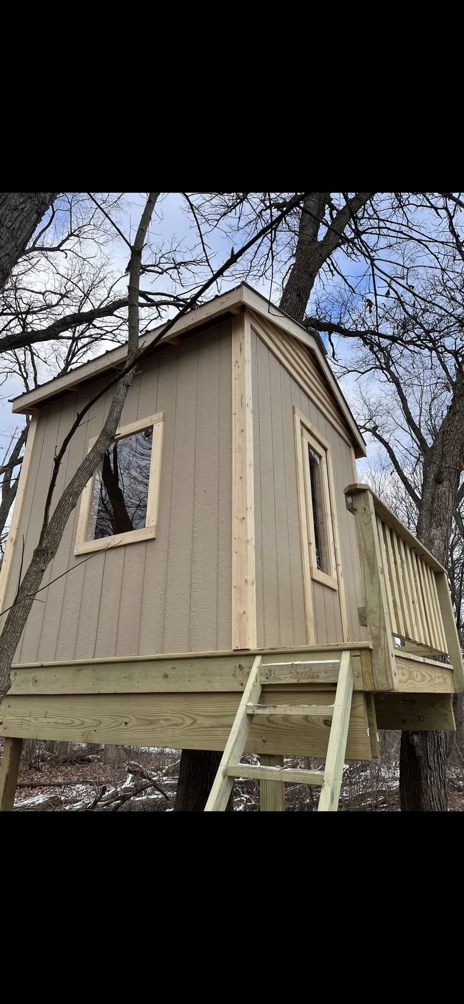 Custom treehouse build with siding and windows NWI